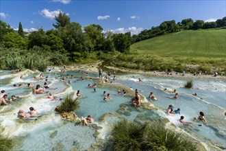 People are bathing in the hot springs of Saturnia Therme