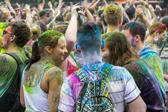 Many young women and man are colored by colorpowder at the colorful Holi festival