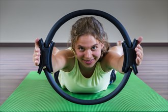 A young woman is training Pilates
