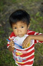 Indigenous boy eating