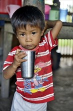 Indigenous boy with a cup