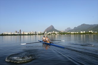 Two young women participating in early morning rowing training in the Lagoa Rodrigo de Freitas Lagoon