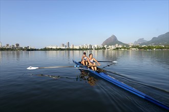 Two young women participating in early morning rowing training in the Lagoa Rodrigo de Freitas Lagoon