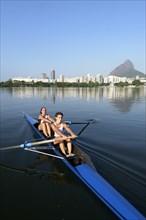 Two young women participating in early morning rowing training in the Lagoa Rodrigo de Freitas Lagoon