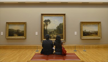 Visitors in front of picture gallery William Turner