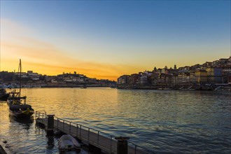 Sunset over Douro river with Rabelo boat and Ribeira district