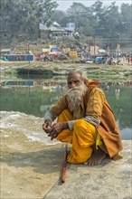 Pilgrim sitting in front of water