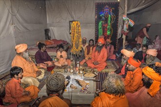 Pilgrims gathered and meditating in a tent