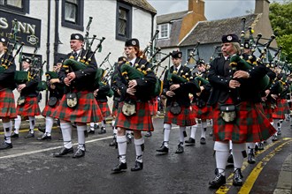 Bagpipers playing instruments in a parade
