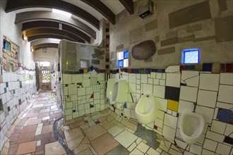 Urinal with ceramic tiles in the public toilet of the artist and architect Friedensreich Hundertwasser