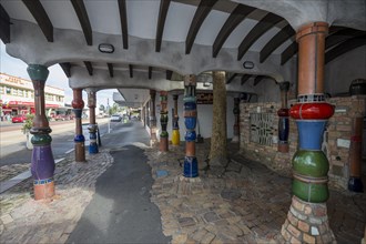 Outdoor area of the public toilet of the artist and architect Friedensreich Hundertwasser with columns and ceramic tiles