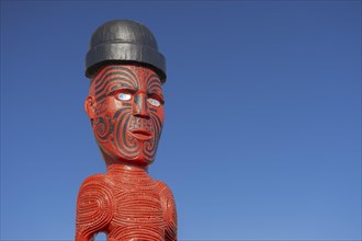 Artfully carved traditional statue of Maori made of wood