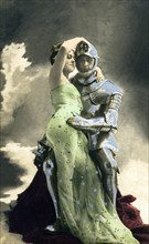 Man in knight's armour embracing a woman in a dress