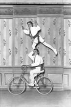 Two acrobats on a bicycle