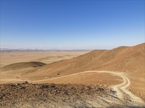 Gravel track through desert landscape