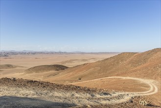 Gravel track through desert landscape