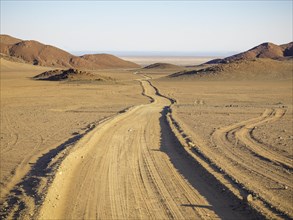 Sand track through desert landscape