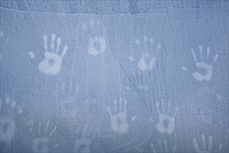 Handprints on ice wall