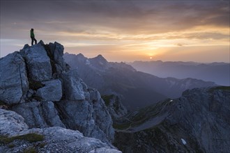 Hiker on top of the Dreitorspitze at sunset