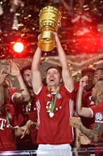 Robert Lewandowski lifting the DFB Cup in the air