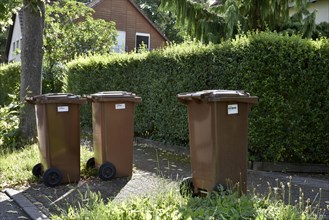Brown garbage bins for organic waste with barcode labels