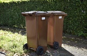 Brown garbage bins for organic waste with barcode labels