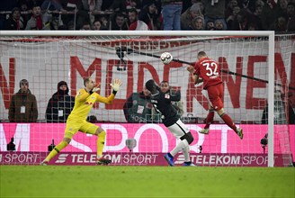 Header Joshua Kimmich FC Bayern Munich against goalkeeper Peter Gulacsi RasenBallsport Leipzig RBL