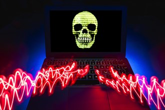 Laptop with skull and crossbones on screen