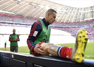 Replacement player Rafinha FC Bayern Munich does stretching exercises at the gang