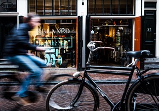 Cyclist rides through shopping street