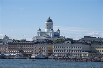 Cathedral of Helsinki behind the houses at the port