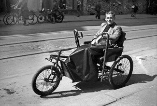 Photographer Karl Heinz Mai in a wheelchair