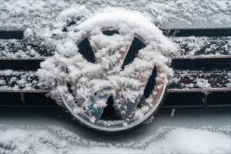 Snow-covered VW logo of VW Golf