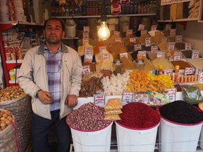 Dealer at spice stall at the market of Kermanshah