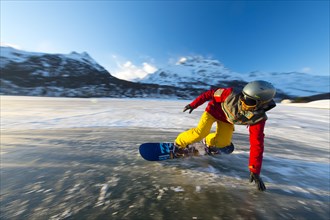 Snowboarder on frozen lake