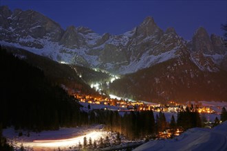 San Martino di Castrozza in front of a snow-covered mountain backdrop in winter