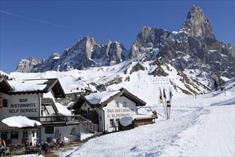 Restaurant at the mountain pass Passo Rolle with snow