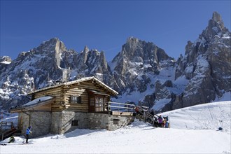 Hikers at mountain hut in the snow