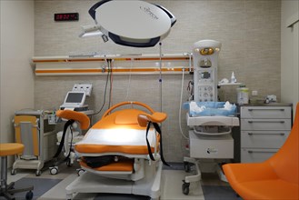 Empty modern delivery room with birthing chair