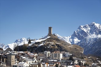 Mountain village Arden with tower of ruin Steinberg in front of snowy mountains