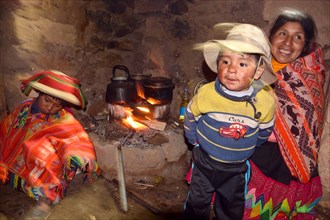 Indio family at the fireplace in their hut