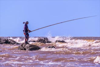 Angler in the surf of the Rio de la Plata