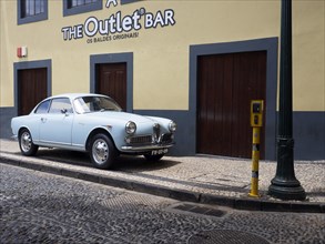 Oldtimer Alfa Romeo Giulietta Sprint 1961 in front of a bar