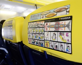 Safety display and advertisement on airplane seat backrest
