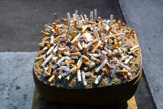 Ashtray with cigarette butts at Skytrain Station