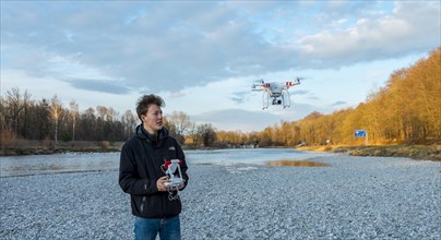 Young man controlling quadcopter