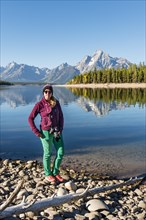 Young woman standing on the shore looking into the camera