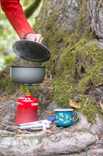Steaming pot stands on camping stove