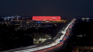 Red lit Allianz Arena at A9 motorway