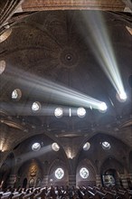 Rays of light shine through windows of the dome